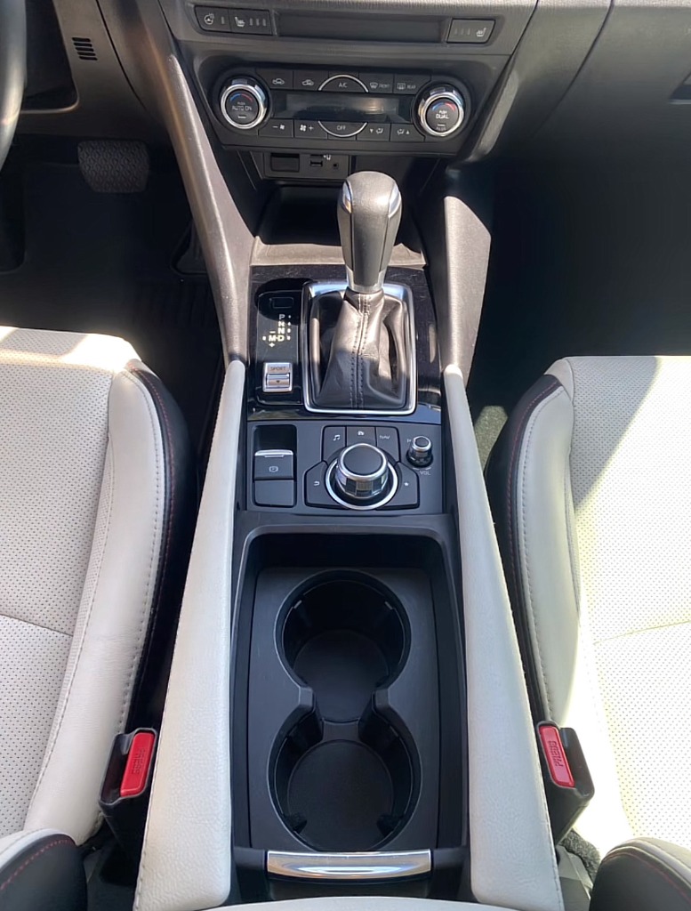 Immaculate steam-cleaned center console and cup holders after auto interior cleaning in Syracuse UT